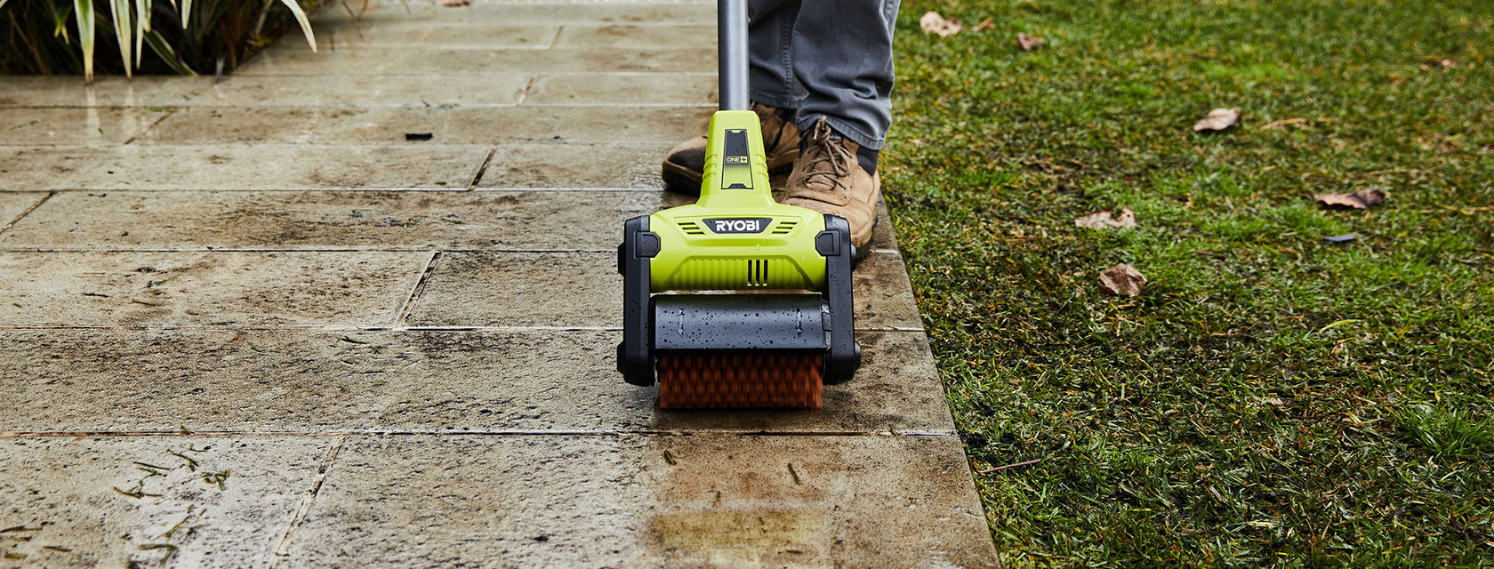 Ryobi scrubbing tool used to clean pavement outdoors