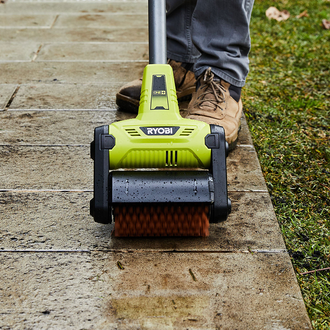 Ryobi scrubbing tool used to clean pavement outdoors