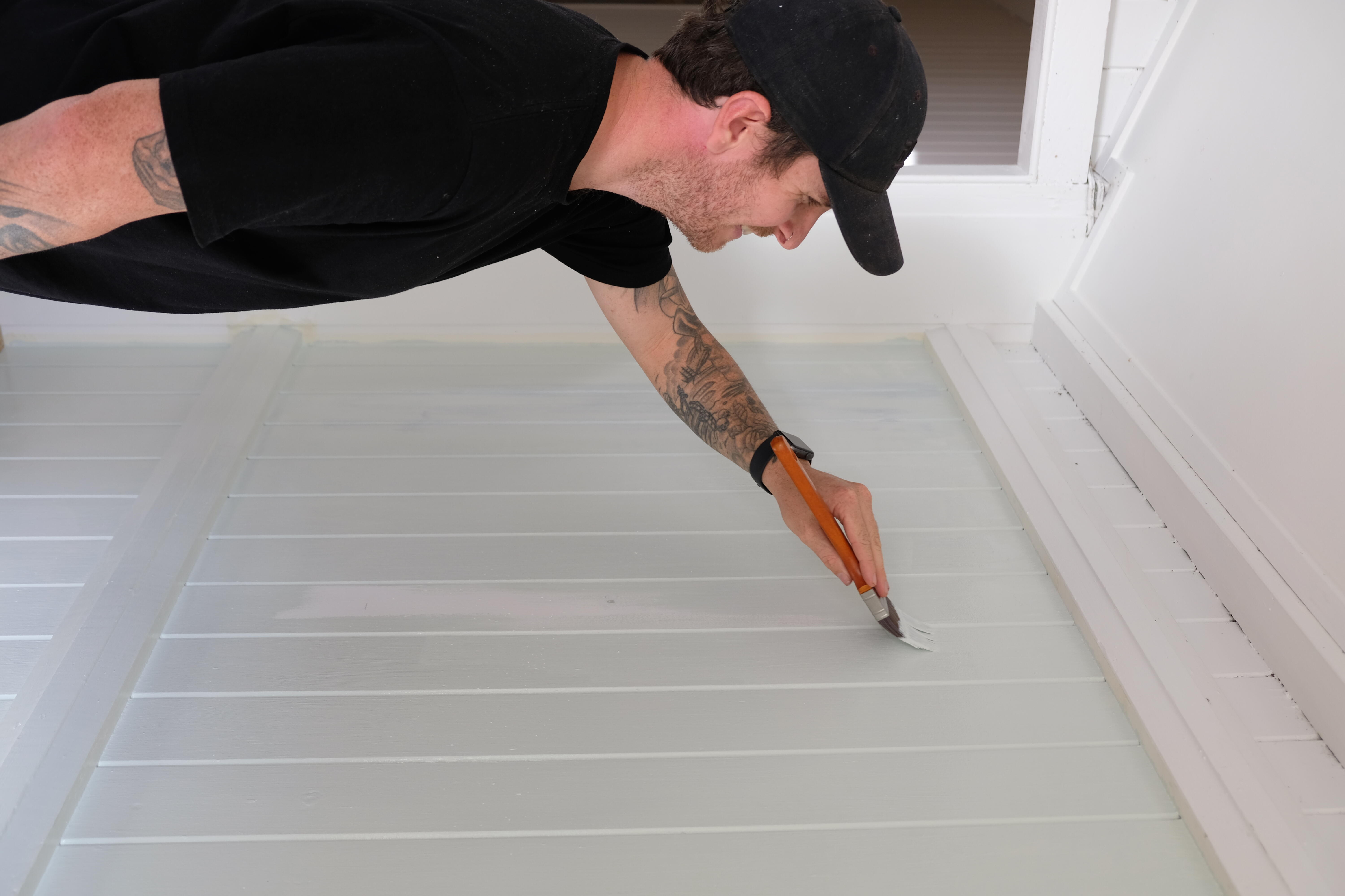  Jake paints the wall behind the shoe cabinet, getting it ready for installation. 