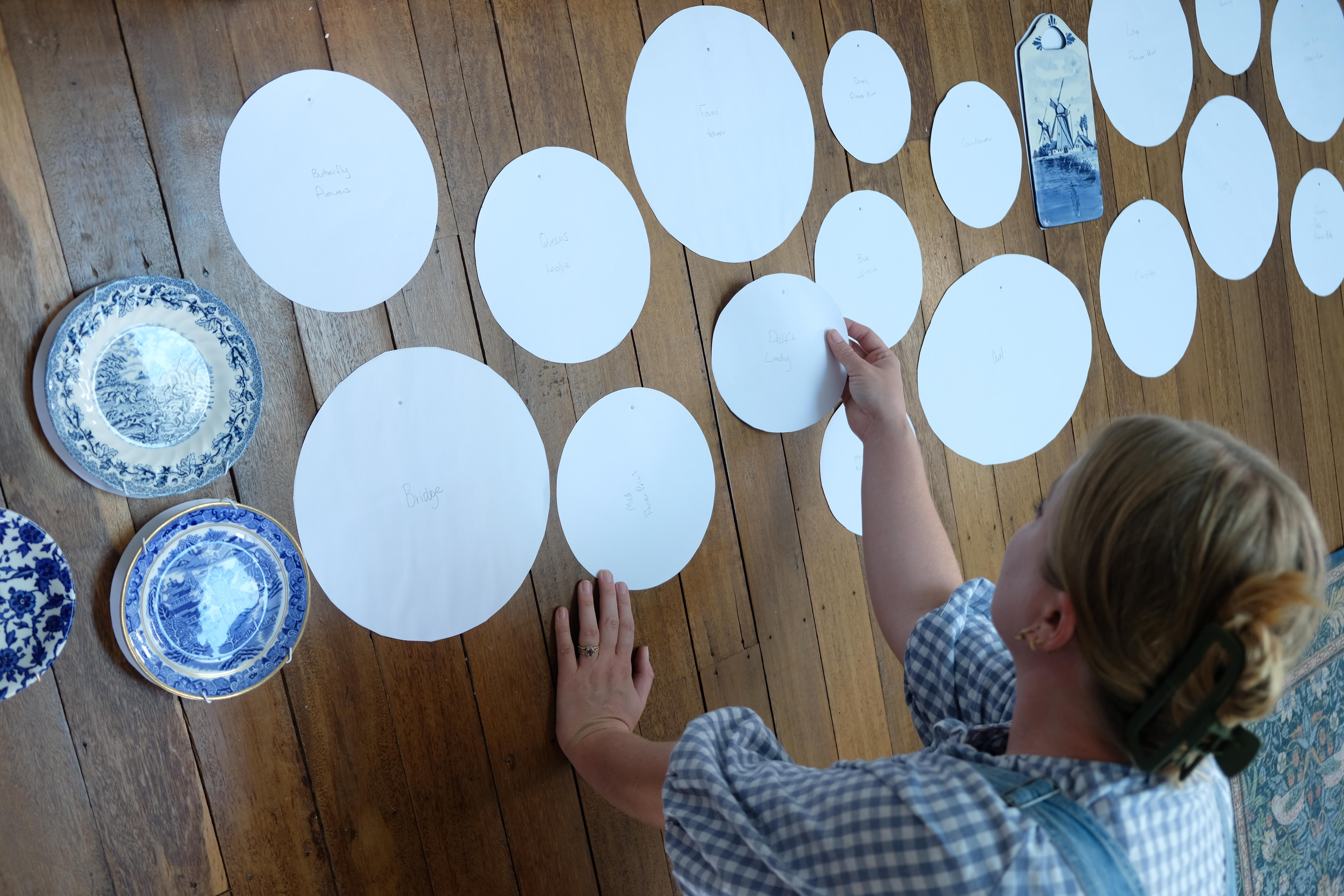 Brooke creates a paper template for each plate to establish the gallery wall layout.